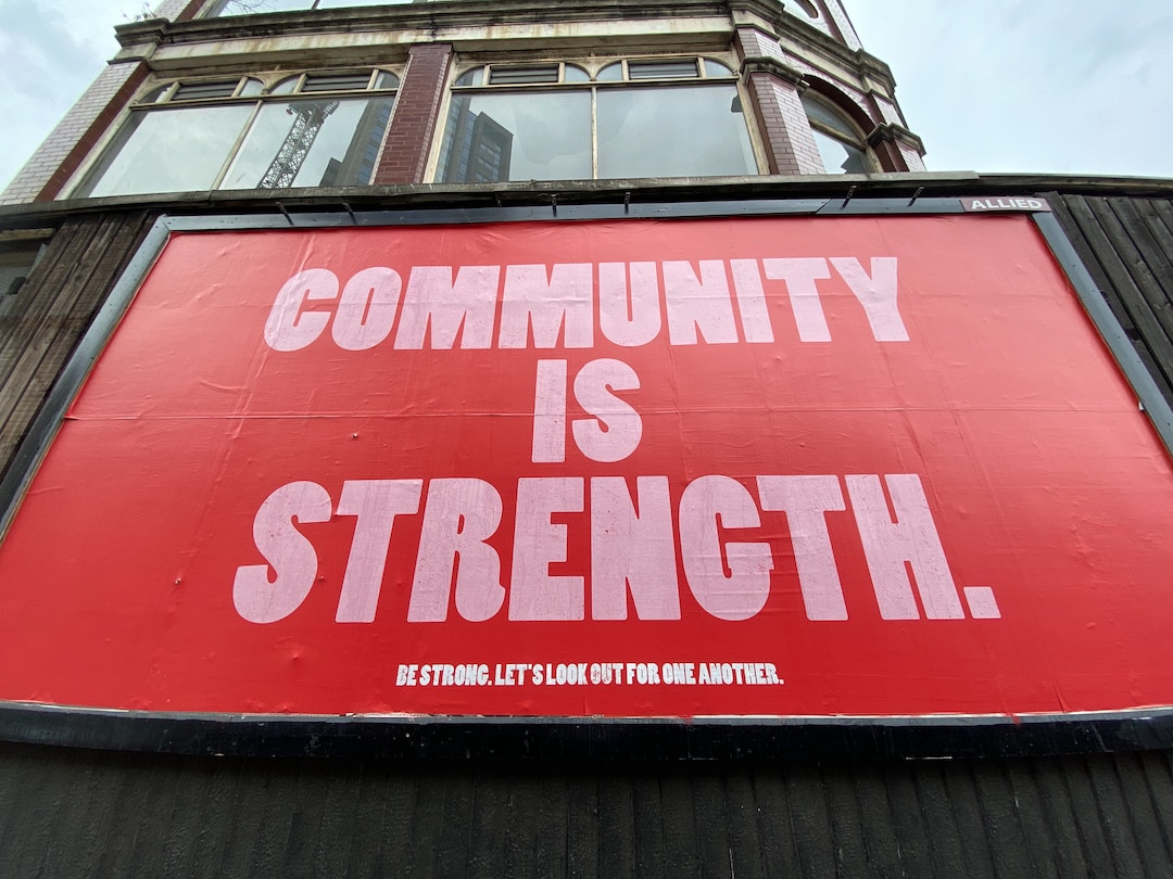 Picture in red backing stating community is strength.